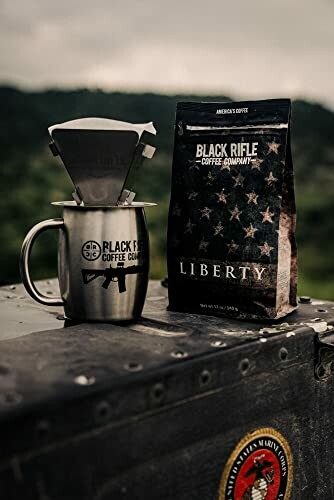 Black Rifle Coffee Company setup with mug and Liberty coffee bag outdoors.