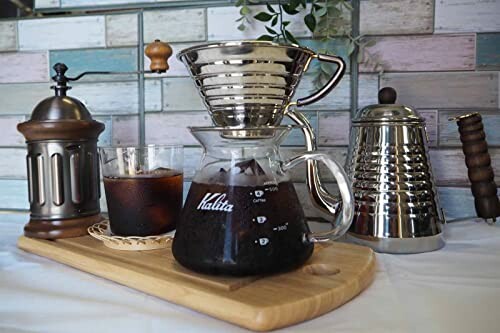 Coffee brewing setup with grinder, drip kettle, and iced coffee.