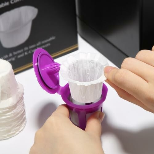 Person inserting a paper coffee filter into a purple holder.