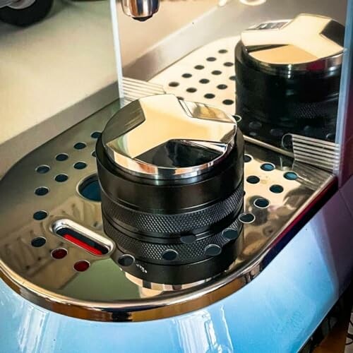 Coffee tamper on espresso machine tray