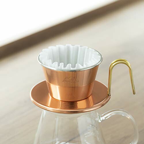 Copper coffee dripper on a glass carafe