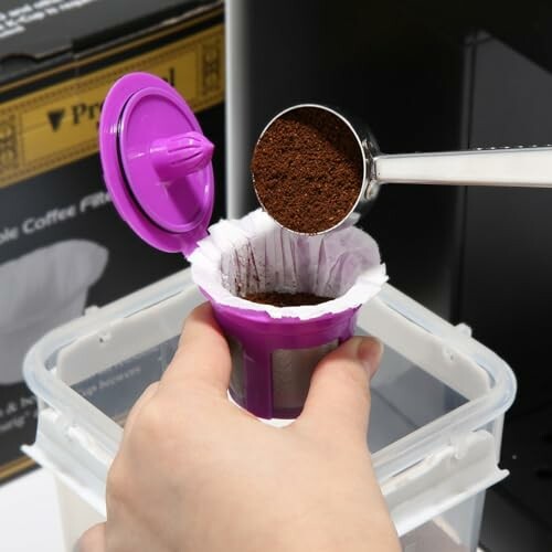 Person filling coffee filter with ground coffee.