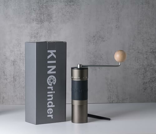 Hand coffee grinder with box labeled 'KIN Grinder'