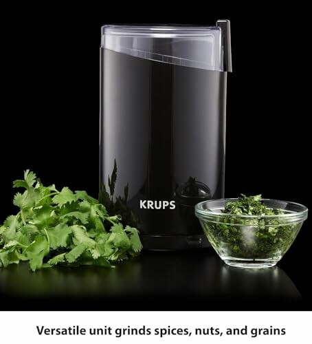 KRUPS grinder with fresh herbs in a glass bowl